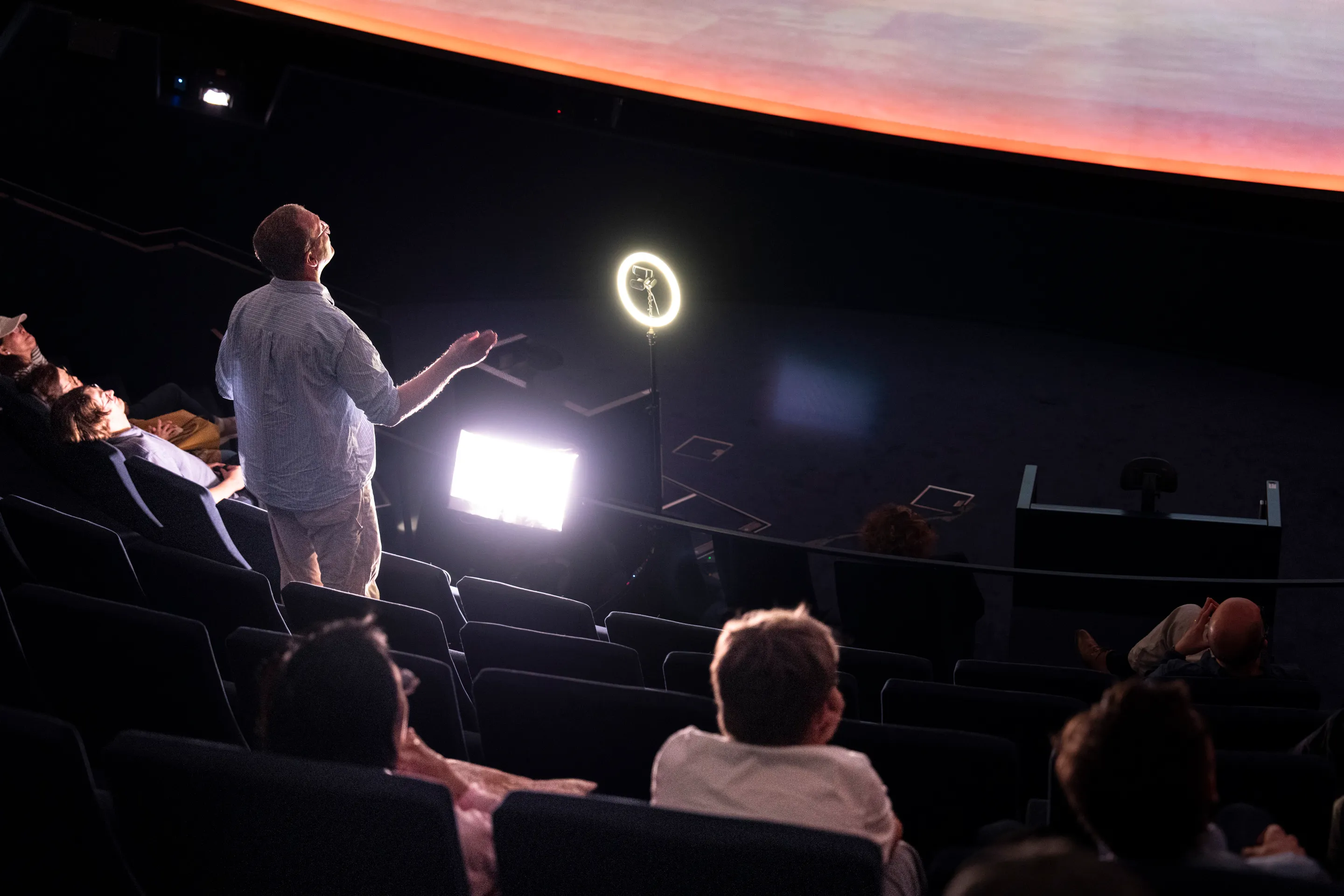 Close-up of a visitor leading the orchestra from the conductor's position